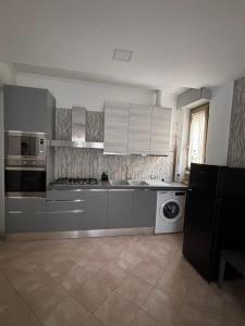 a kitchen with a sink and a stove top oven at Casa Palma in Rho +7 photos