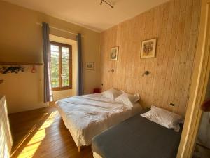 a bedroom with a bed and a bench in it at Le Colombier d'Antan in Les Vans +24 photos