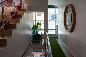 a staircase in a house with a green carpet at Hotel satkar in Parāsia +2 photos