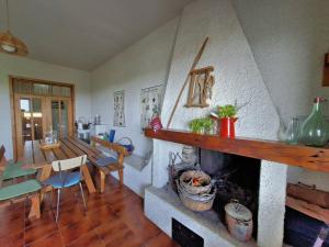 a living room with a fireplace and a dining room at White Cottage - WelcHome in Mozzagrogna