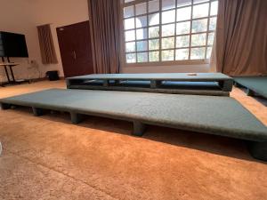 two beds sitting in a room with a window at Project ADAM in Ras al Khaimah