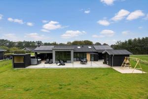 a large black house with a large yard at OH513-Hadsund-Haslevgarde-Eng-14 in Hadsund