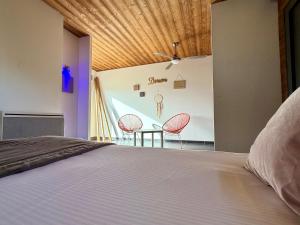 a bedroom with a bed and a table and chairs at Bio-Motel in Saint-Vulbas
