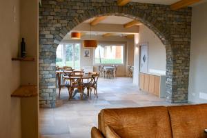 an archway in a dining room with tables and chairs at Agriturismo De Ferrari in Onzo