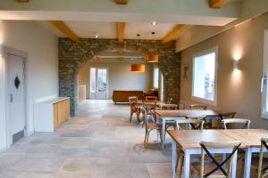 a restaurant with tables and chairs and a couch at Agriturismo De Ferrari in Onzo