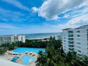 a view of the pool and the ocean from the balcony of a resort at Ocean Vista Mai House in Ấp Phú Tịnh (2)