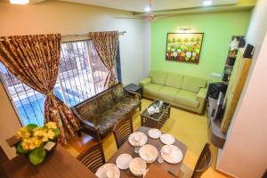 a living room with a table and a couch at Klassone Bunglow in Khandāla +1 photo
