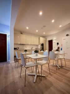 a dining room with tables and chairs and a kitchen at Apartment 81 in Mosta +31 photos