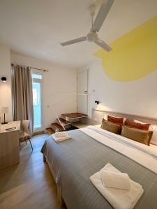 a bedroom with a large bed and a desk at Apartment 81 in Mosta