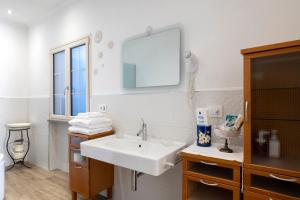a bathroom with a white sink and a mirror at La Dimora di B.Cairoli in Ovada +47 photos