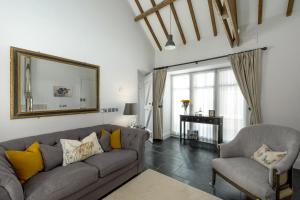 a living room with a couch and a chair and a mirror at 1 Bed in Lowick oc-coq44 in Holburn