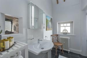 a white bathroom with a sink and a chair at 1 Bed in Lowick oc-coq44 in Holburn +17 photos
