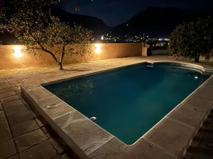 a swimming pool in a backyard at night at Villa Ideal in Sóller