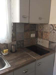 a kitchen with a sink and a counter top at Sea Sun Sand in Loutra +8 photos