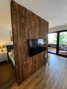 a large wooden wall with a television in a room at Chalet-Apartment Waldfrieden, in ruhiger Lage mit TG in Hahnenklee-Bockswiese