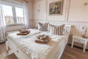 a bedroom with a white bed with towels on it at Penthouse Meeresrauschen in Dierhagen
