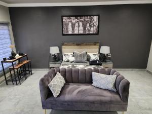a living room with a couch and a bed at South Gate Country Lodge in Polokwane