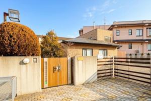 a house with a gate and a fence at Yunokawa Onsen KOMOREBISO in Hakodate