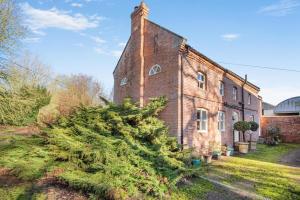 an old brick building with a christmas tree in front of it at 2 Bed in Caenby oc-o35799 in Caenby