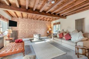 a living room with a couch and a brick wall at 2 Bed in Caenby oc-o35799 in Caenby