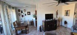 a living room with a flat screen tv and a table at Marseille Estaque in Marseille