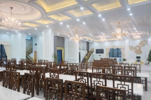 a banquet hall with tables and chairs and chandeliers at Balat Resort in Tập Thiện