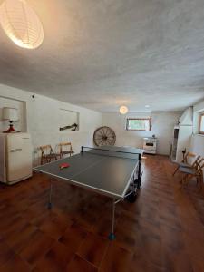 a ping pong table in the middle of a living room at White Cottage - WelcHome in Mozzagrogna