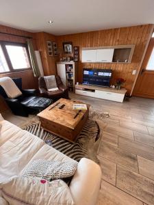 a living room with a couch and a coffee table at Bellissimo Chalet con vista in Faido