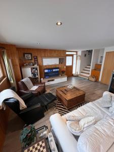 a large living room with couches and a television at Bellissimo Chalet con vista in Faido