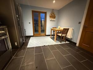 a kitchen with a table and a dining room at Our Garden View Room in Bedford