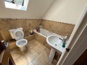 a bathroom with a toilet and a sink at Our Garden View Room in Bedford +21 photos
