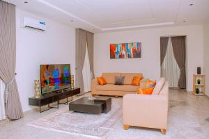 a living room with a couch and a tv at House 24 Jahi in Kadobunkuro +17 photos