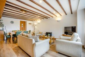 a living room with chairs and a table and a dining room at 2 Bed in Knayton oc-b35995 in Knapton