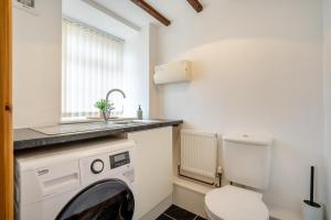 a bathroom with a washing machine and a sink at 2 Bed in Knayton oc-b35995 in Knapton +23 photos