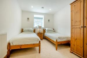 a bedroom with two beds and a dresser at 2 Bed in Knayton oc-b35995 in Knapton
