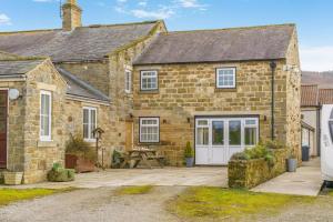 an old stone house with a patio in front of it at 2 Bed in Knayton oc-b35995 in Knapton