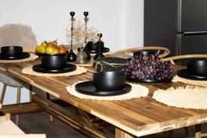 a wooden table with bowls of fruit on it at Lucky Strike Hostel in Bad Oldesloe +49 photos
