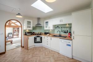 a kitchen with white cabinets and a white refrigerator at 1 Bed in Staxton oc-w36041 in Salton