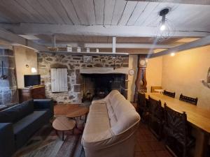 a living room with a couch and a fireplace at Nouveau - Maison Nierveze proche Lioran in Thiézac