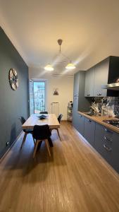 a kitchen with a table and a dining room at Appartamento Sole&Luna in Sulmona
