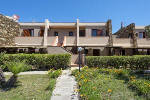 a house with a garden in front of it at L11 Terrazza Maestrale in Stintino