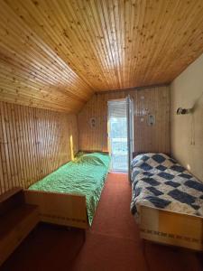 a bedroom with two beds in a wooden room at Mavrovo Lake Chalet in Mavrovo