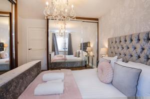 a bedroom with a large bed with a large mirror at Holgate Lodge in York