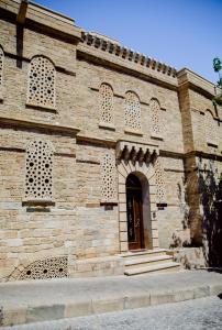 a large brick building with a door and stairs at Royal Historical Boutique Hotel in Baku