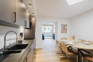 a kitchen and dining room with a table and chairs at "Happy Vibes" City Appartment in Passau