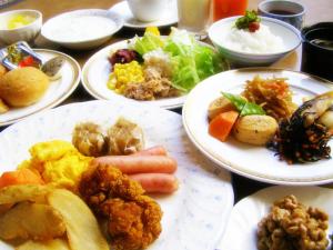 a table full of plates of food with different foods at Hotel Tsubame Hills in Tsubame