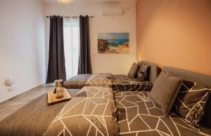 a living room with a bed and a couch at St Julians`s Boho Apartments in Is-Swieqi