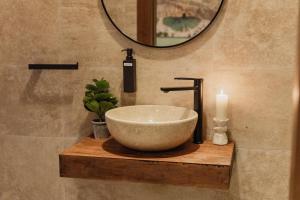 a bathroom with a bowl sink and a mirror at St Julians`s Boho Apartments in Is-Swieqi +65 photos