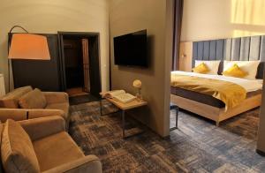 a hotel room with a bed and a couch at H24 Parkhotel Thale in Thale +62 photos