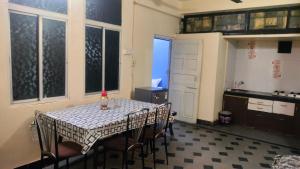 a kitchen with a table and chairs in a room at Atithi homestay Solapur in Solapur